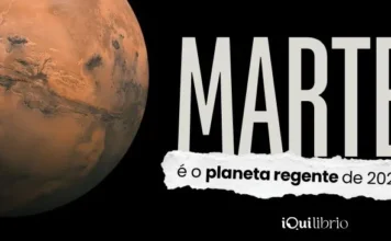 O planeta regente de 2026 é Marte e isso muda o tom do seu ano Imagem institucional da iQui, com o planeta Marte e texto "Marte é o planeta regente de 2026"